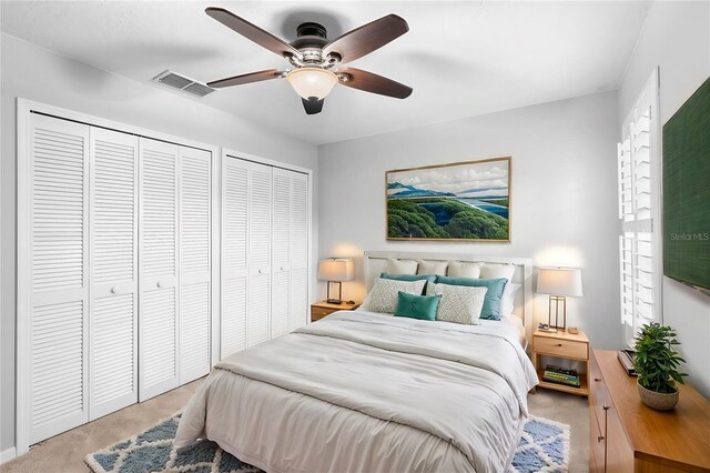 2626 Raccoon Run Ln, Orlando, FL 32837 - bedroom featuring multiple closets, carpet flooring, and ceiling fan