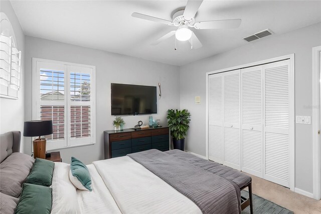2626 Raccoon Run Ln, Orlando, FL 32837 - bedroom with light colored carpet, a closet, baseboards, and a ceiling fan