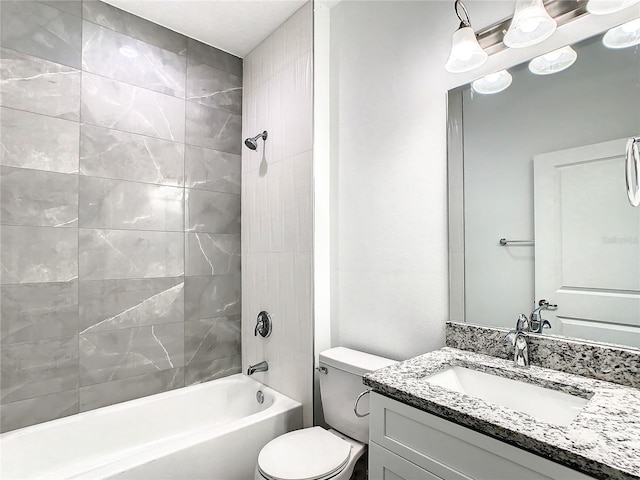 full bathroom with vanity, toilet, and tiled shower / bath