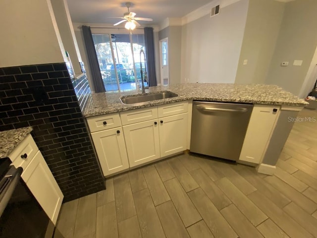 kitchen featuring dishwasher, kitchen peninsula, white cabinetry, and light hardwood / wood-style flooring