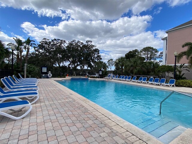 3468 Soho St Unit 107, Orlando, FL 32835 - community pool featuring a patio area and a community hot tub