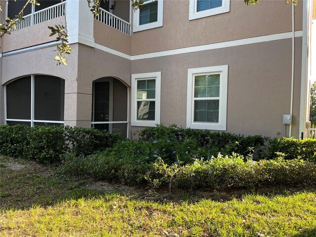 3468 Soho St Unit 107, Orlando, FL 32835 - view of home's exterior featuring stucco siding and a balcony