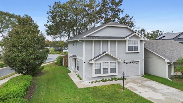 front facade featuring a garage and a front yard