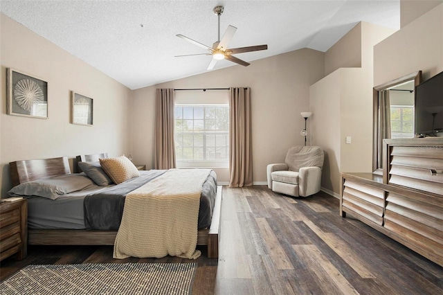 bedroom featuring multiple windows, ceiling fan, dark hardwood / wood-style floors, and vaulted ceiling