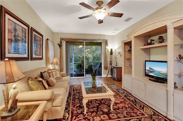 living room featuring hardwood / wood-style floors and ceiling fan