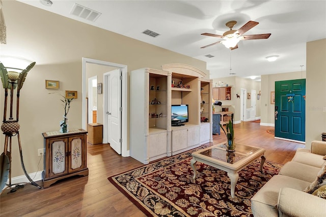 living room featuring ceiling fan and wood-type flooring