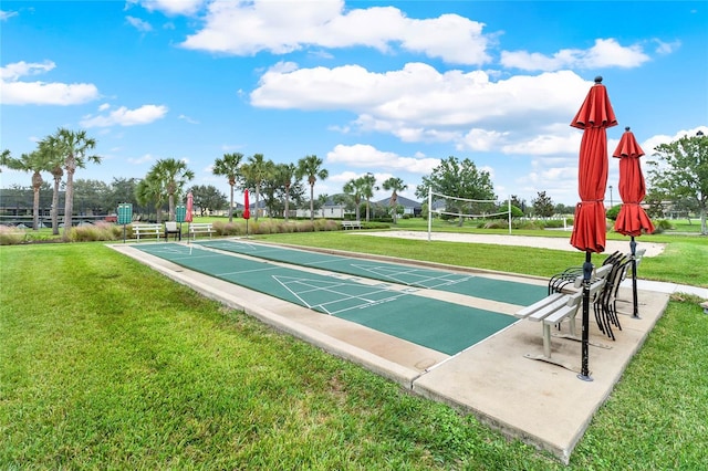 view of property's community featuring a lawn and volleyball court