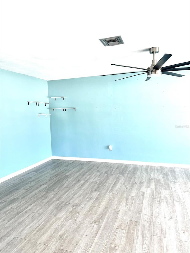 spare room with ceiling fan and light hardwood / wood-style floors