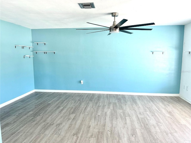 unfurnished room with ceiling fan and light wood-type flooring