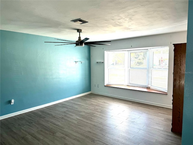 unfurnished room featuring ceiling fan, wood-type flooring, and a textured ceiling