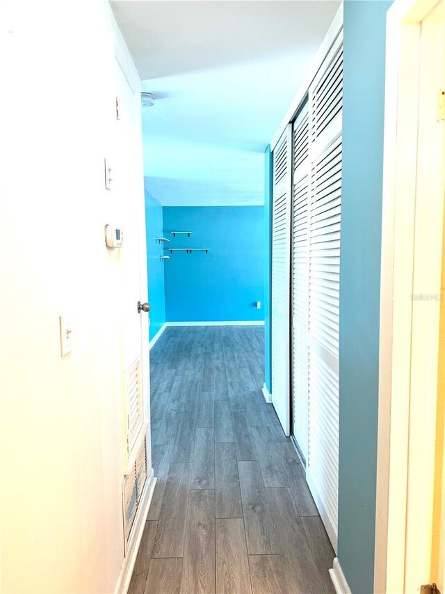 hallway with dark wood-type flooring