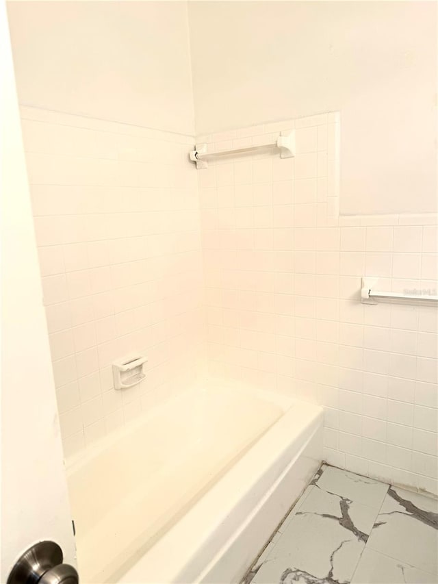 bathroom with tile walls