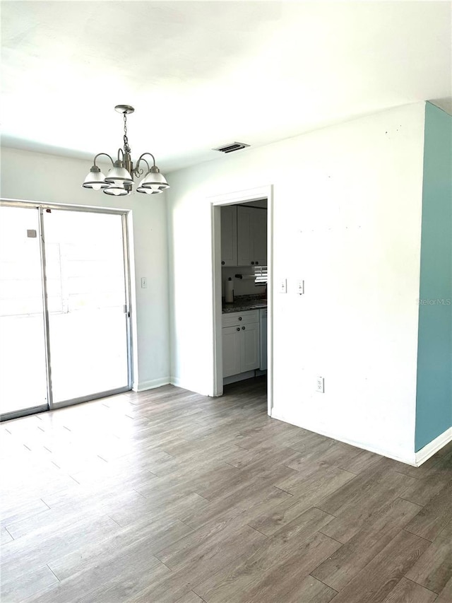 interior space with hardwood / wood-style flooring and a notable chandelier