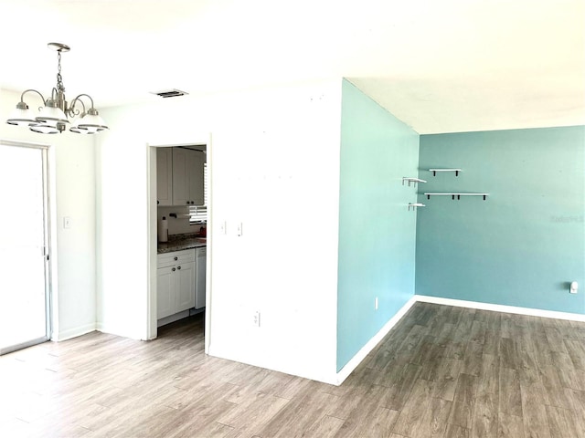 interior space with a chandelier and light hardwood / wood-style flooring