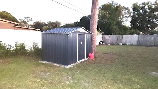 view of outdoor structure featuring a lawn