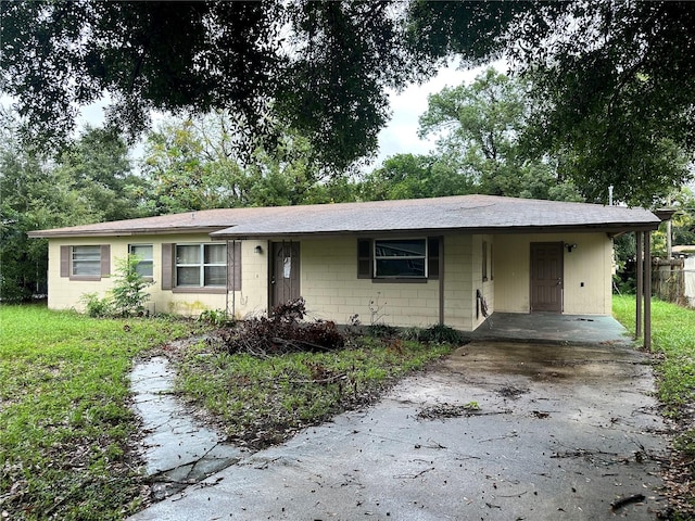 ranch-style house featuring a carport