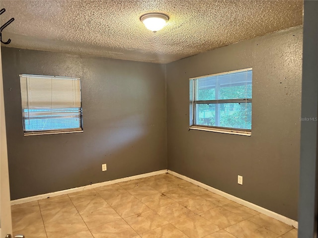 spare room with a textured ceiling