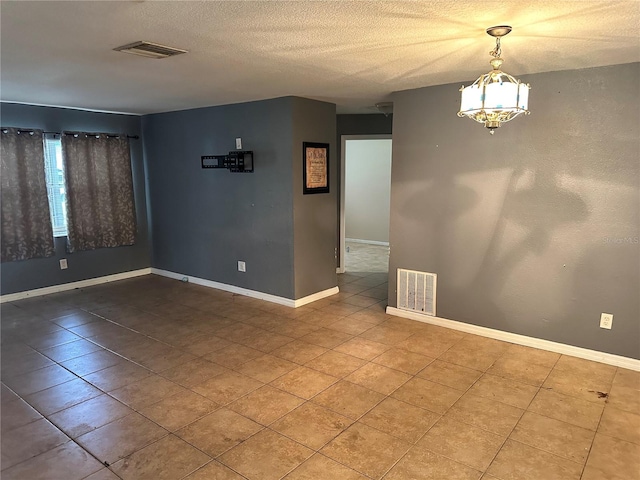 empty room with a textured ceiling