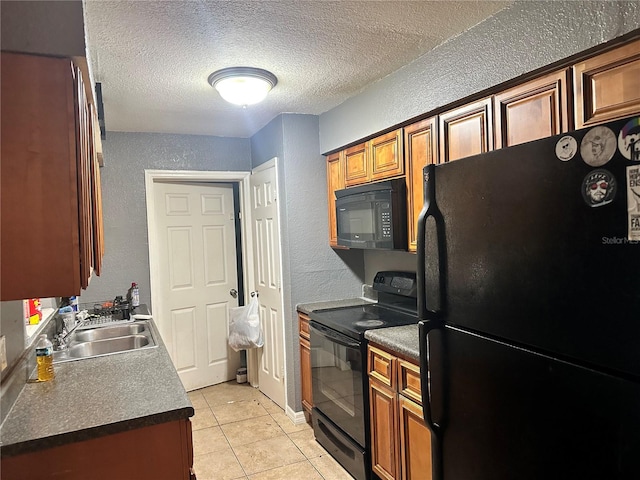 kitchen with light tile patterned floors, a textured ceiling, sink, and black appliances