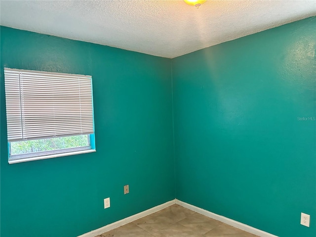 spare room featuring a textured ceiling