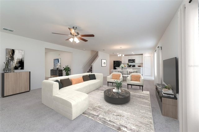 carpeted living room with ceiling fan with notable chandelier