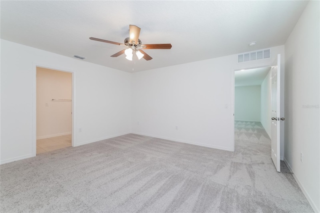 unfurnished room featuring light carpet and ceiling fan