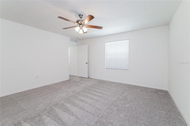 carpeted empty room featuring ceiling fan