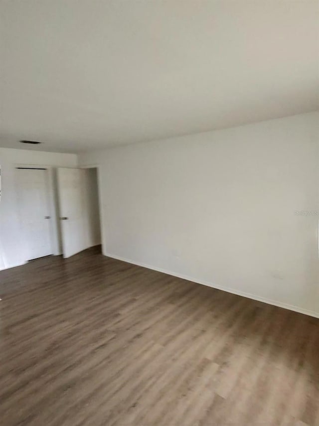 empty room featuring dark wood-type flooring