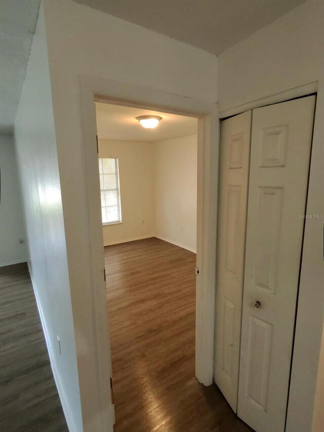 6008 Village Cir Unit Ge, Orlando, FL 32822 - hall featuring dark wood finished floors and baseboards