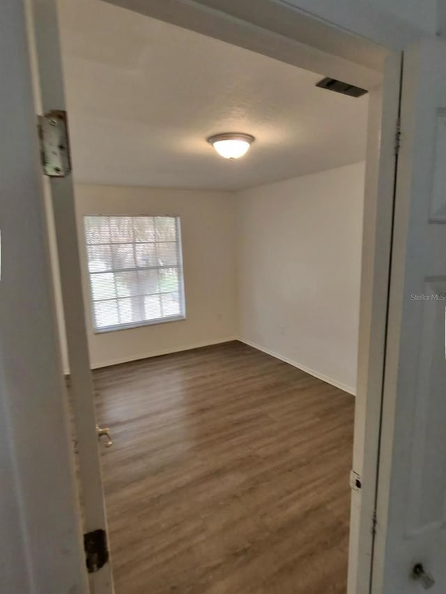 spare room featuring dark hardwood / wood-style flooring