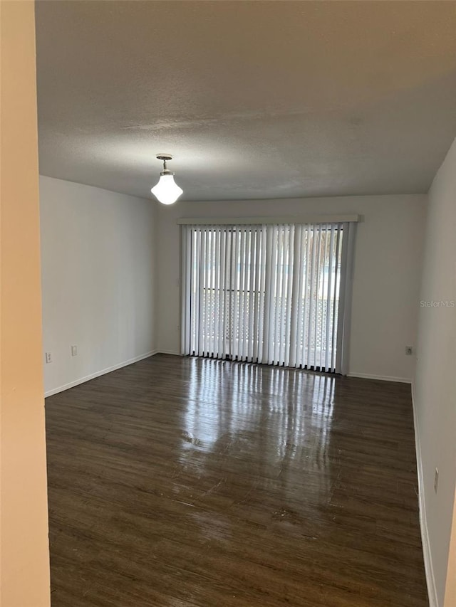 unfurnished room with a textured ceiling