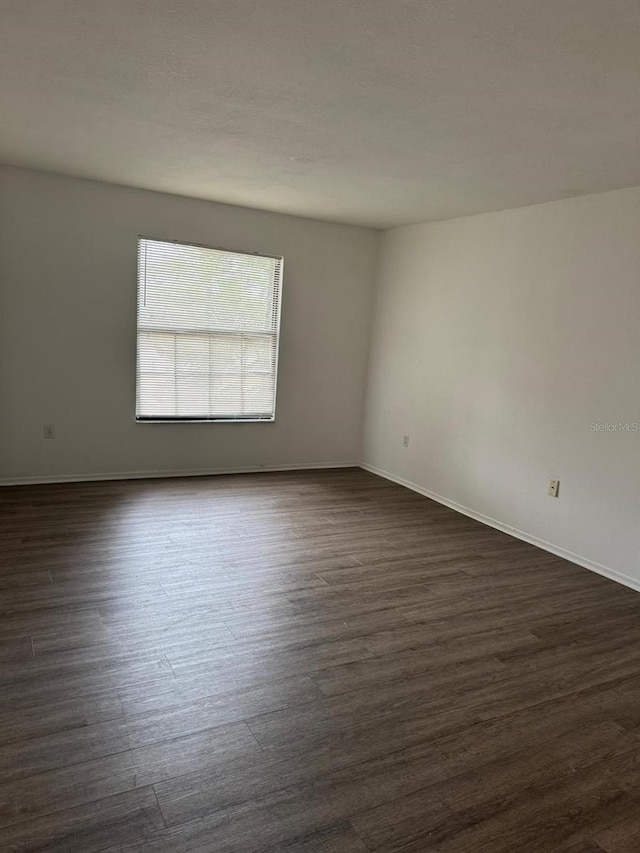 unfurnished room featuring dark hardwood / wood-style floors