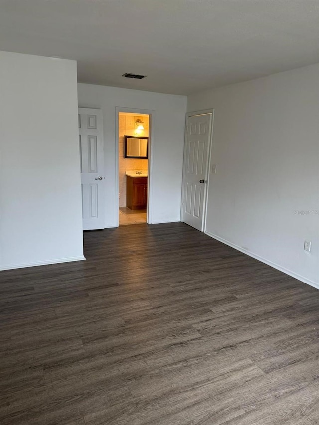 empty room with dark hardwood / wood-style floors