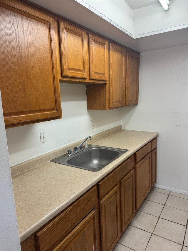 kitchen featuring sink and light tile patterned flooring