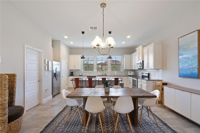 dining room featuring sink and a notable chandelier