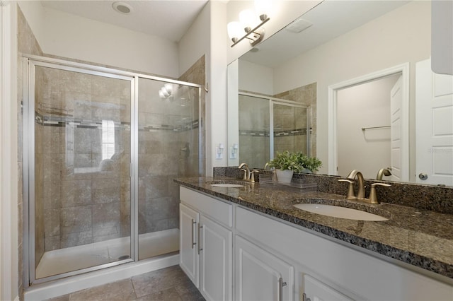 bathroom featuring vanity, an enclosed shower, and tile patterned floors