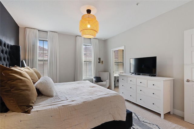 bedroom featuring light carpet