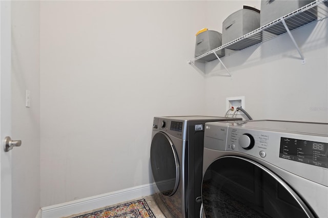 laundry room featuring separate washer and dryer and wood-type flooring