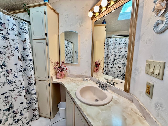 bathroom with vanity, tile patterned flooring, a textured ceiling, and a shower with curtain