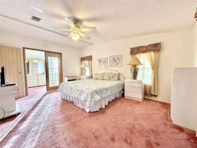 bedroom with a textured ceiling, carpet flooring, and ceiling fan