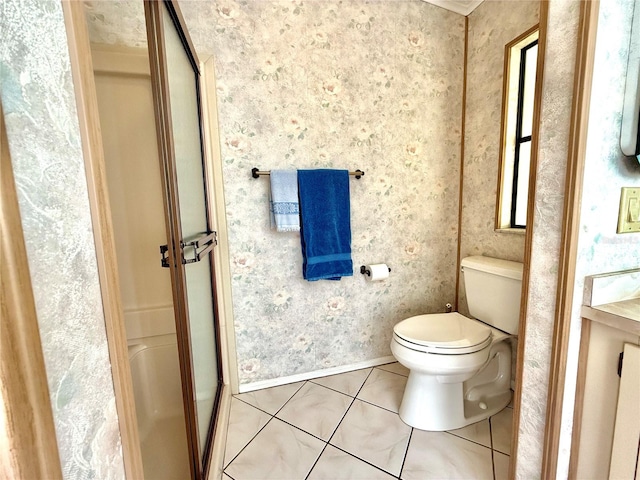 bathroom featuring tile patterned flooring, vanity, toilet, and a shower with door