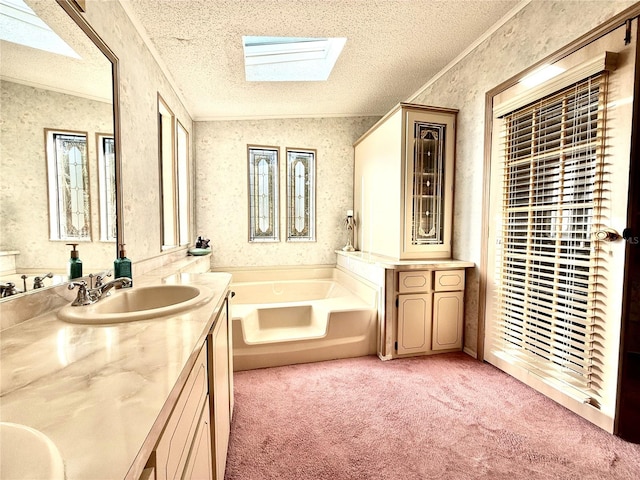 bathroom featuring vanity, a textured ceiling, and a tub to relax in