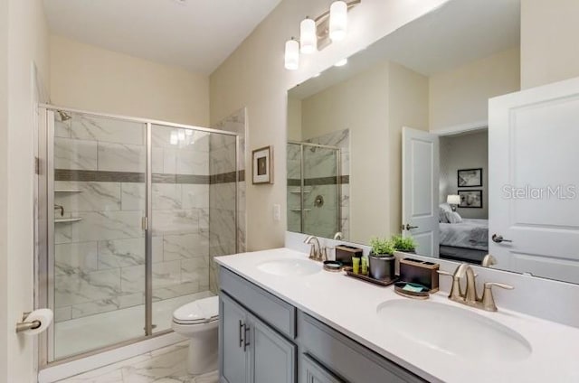 bathroom with toilet, an enclosed shower, and vanity