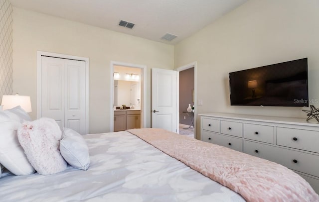 bedroom with ensuite bathroom and a closet