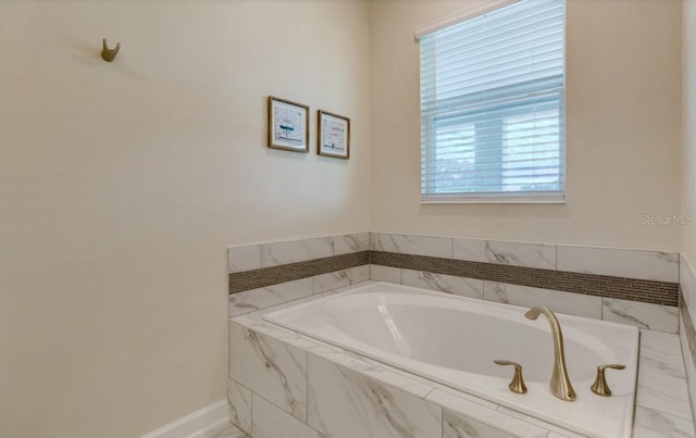 bathroom featuring a relaxing tiled tub