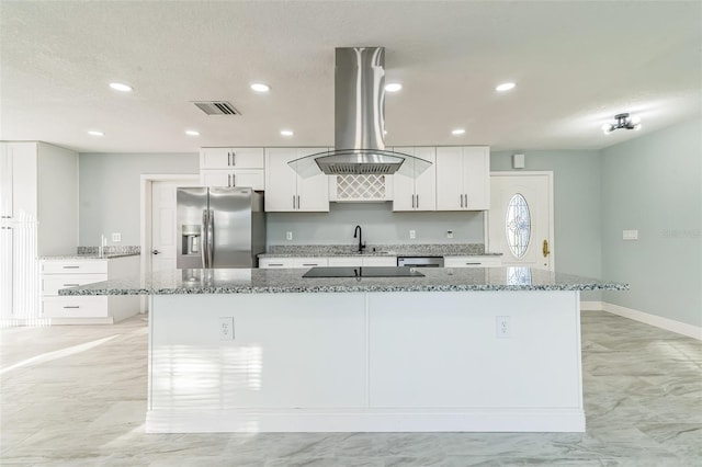 kitchen with island exhaust hood, appliances with stainless steel finishes, a large island, and stone countertops