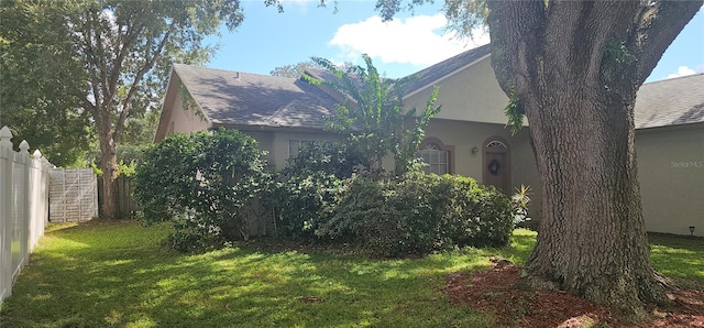 view of side of property with a lawn