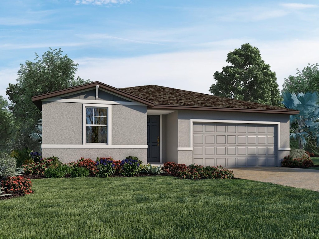 view of front of home featuring a front lawn and a garage