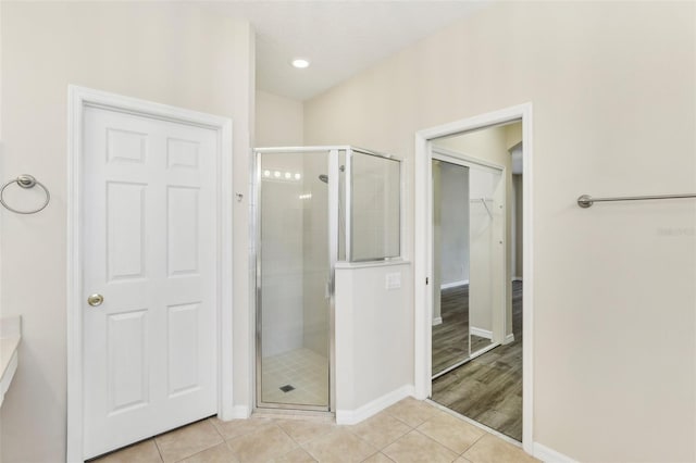 bathroom featuring wood-type flooring and a shower with door