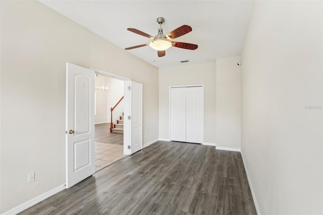 unfurnished room featuring ceiling fan and dark hardwood / wood-style floors